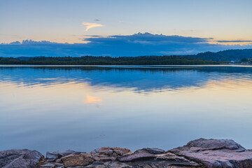 Sunrise waterscape with cloud reflections