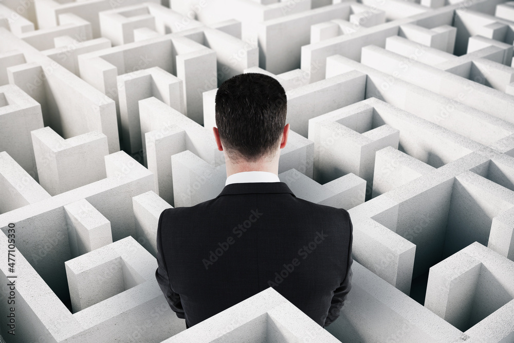 Poster Back view of businessman in suit looking at white maze. Solution and challenege concept.