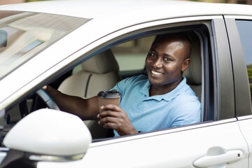 Smiling african american man driver drinking coffee