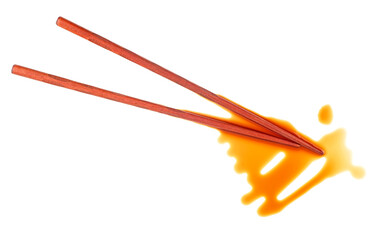 Splashes of soy sauce and wooden chopsticks isolated on a white background, top view. Japanese food.