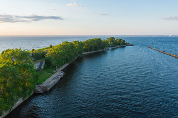 Fototapeta na wymiar Panoramic aerial view of Fort Totleben Pervomaisky on a summer day in the waters of the Gulf of Finland.One of the fortifications of Kronstadt.Kronstadt Fortress. Concrete walls and ridges under water