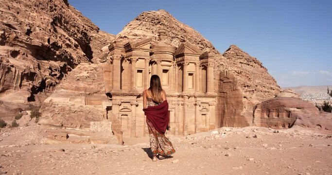 Woman walking in in front of the Monastery, in the ancient city of Petra, Jordan