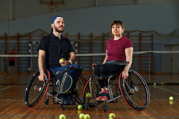 Fototapeta premium pair of disabled tennis players hugging each other