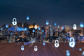 Rooftop with wooden terrace, Kuala Lumpur night skyline. Cyber security concept to protect clients confidential information. IT hologram padlock icons. City downtown. Double exposure.