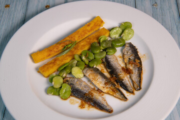 RECIPE OF SARDINE FILLETS MARINATED WITH CHILI, POLENTA WITH BEANS, SEEFOOD. High quality photo