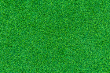 The green artificial grass in the football field is taken from above, or it can be artificial grass in the garden, can be used as a background. Suitable for sports or home and garden work.