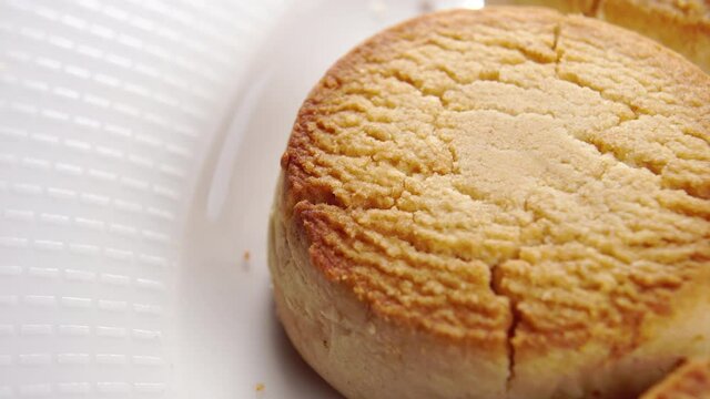 Typical spanish polvorones. Traditional shortbread cookies in white plate. Spain. Macro. Rotation