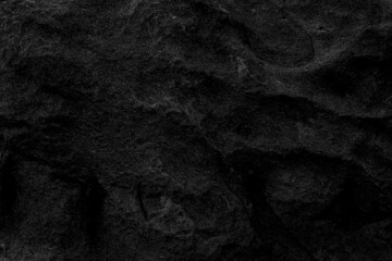 Mysterious black stone floor or maybe a cave wall in the dark can be used as wallpaper, suitable for work related to geology or nature and minerals, or to be used in architecture and home related work