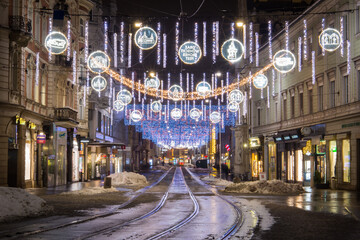 Fototapeta na wymiar Christmas lights wishing Frohes Fest in the winterly city of Graz in Austria