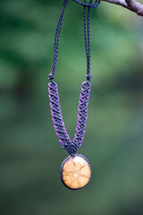 Boho necklace on natural background with ayahuasca root decoration