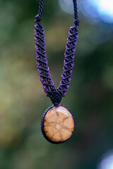 Boho necklace on natural background with ayahuasca decoration