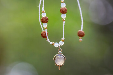 Boho necklace on natural background with moon stone
