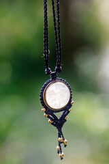 Boho necklace on natural background with white moonstone