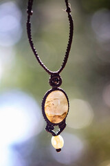 Boho necklace on natural background with grey labradorite stone