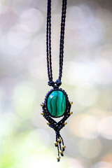 Boho necklace on natural background with green malachite stone