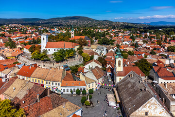 Szentendre, Hungary - Aerial view of the main square of Szentendre on a sunny day with Saint John the Baptist's Parish Church, Blagovestenska Church, Saint Peter and Paul Church and clear blue sky