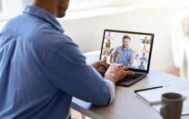 Remote Communication. Unrecognizable Businessman Teleconferencing With Colleagues, Using Laptop Computer In Office