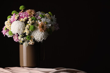 Bouquet of beautiful chrysanthemum flowers on table against dark background, space for text