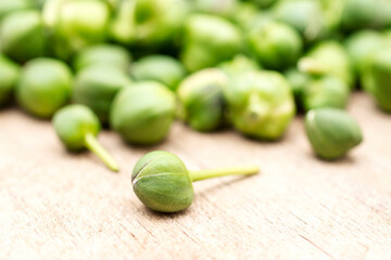 Fresh capers on wooden background.