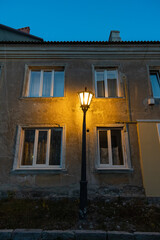 Facade of an old town house with an old street lantern, built in the late 19 century....
