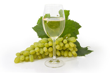 Glass of white wine against the white grapes cluster