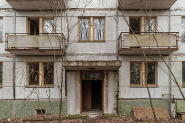 Fototapeta na wymiar Entrance to an abandoned prefabricated house in the Chernobyl Exclusion Zone. Chernobyl, Ukraine.