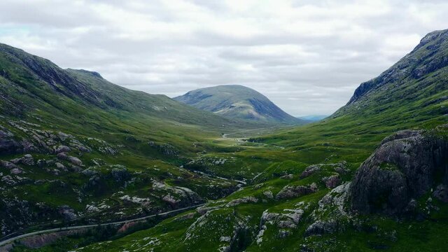Aerial Drone Shot of Road Through Scotlands Glen Coe Hills. High quality video footage