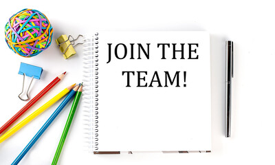 Notebook ,pencils,pen and rubber band with text JOIN THE TEAM on the white background