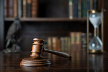 Judge office. Gavel, scale and law books in the bookshelf.