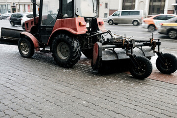 clears snow on the city street