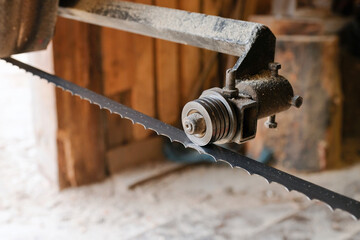 Details of a saw for processing and cutting wood at a sawmill close-up