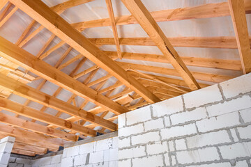 New construction of the house. Constructing a roof from timber beams