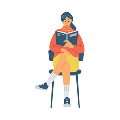 Fototapeta premium Pretty girl reads book sitting on chair, student studies scientific literature