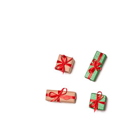 Mini gift boxes that can be hung on Christmas trees to celebrate the arrival of Santa Claus. Boxes of different colors.  christmas gifts with red ribbon bows on a white background with space to copy
