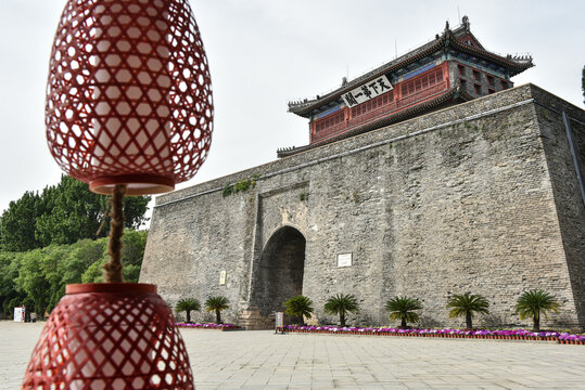 Shanhaiguan, Qinhuangdao City, Hebei Province, China -- May 17, 2020: Chinese red lanterns are in the foreground of the Arrow Tower of Shanhaiguan, an ancient structure of the Great Wall of China - Powered by Adobe