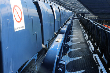 Empty seats on grandstand social distancing.	