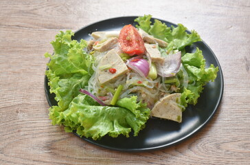 glass noodles with Vietnamese sausage and chop pork spicy salad on plate