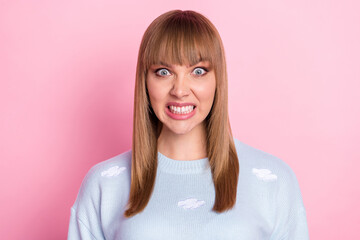 Portrait of attractive crazy evil girl hate expression grinning teeth isolated over pink pastel color background