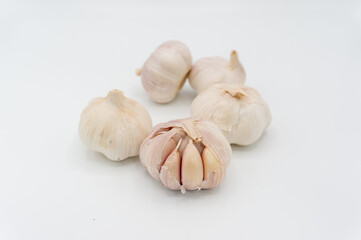 Ripe garlic.Some garlic heads photographed against a white background. Still life shot. Purple and white garlic heads.