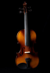 Fototapeta na wymiar Light and shadows on a violin against a dark background.