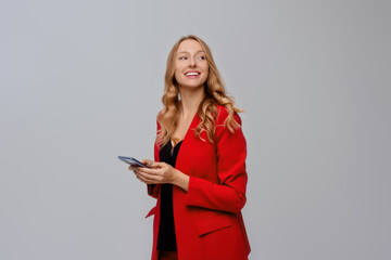 Portrait of successful young woman entrepreneur, holding cellphone her hands, smiling and looking...