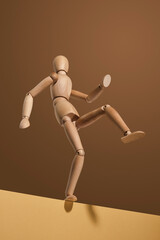 Decisive man going to take a step across abyss on brown and beige background. Success and great future.