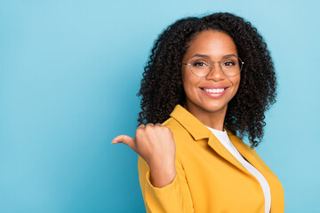 Profile side photo of young black woman happy positive smile point thumb empty space ad suggest...