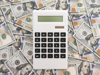 Calculator on one hundred dollars bills background