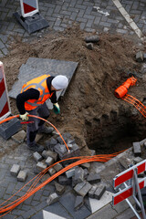 Installation of fibre optic cables by constructions workers to neighbouring houses - 477129146