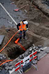 Installation of fibre optic cables by constructions workers to neighbouring houses