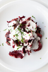 Grilled beetroot salad on white plate.