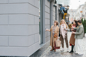 Older women, best friends have fun walking the streets of the city shopping.