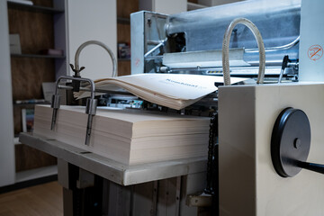 offset press with sheets of printed paper