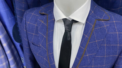 blue male suit and tie, clothes on manikin in shop, modern collection